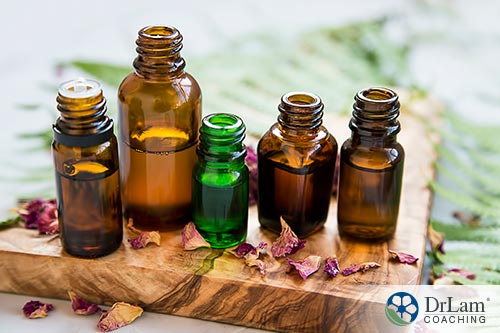 An image of 5 glass bottles of different shapes and sizes containing essential oils