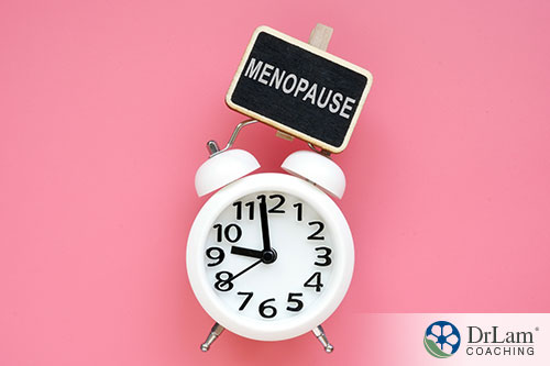an illustration of the word menopause showing time is running out with a pink background