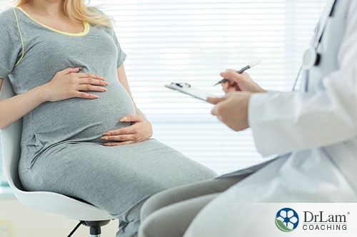 An image of a pregnant woman talking with her doctor