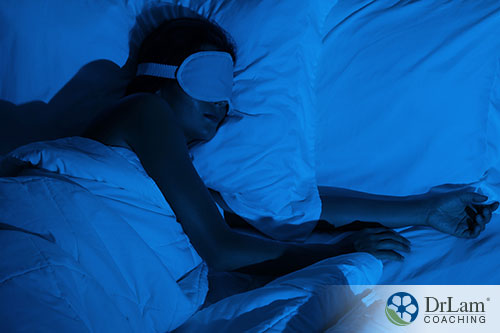 An image of a woman sleeping with an eye mask