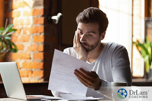 An image of a stressed man looking at a paper