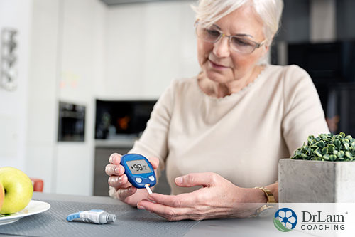 An image of an older woman testing her blood glucose