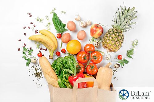 An image of a paper bag with healthy foods pouring out of the top