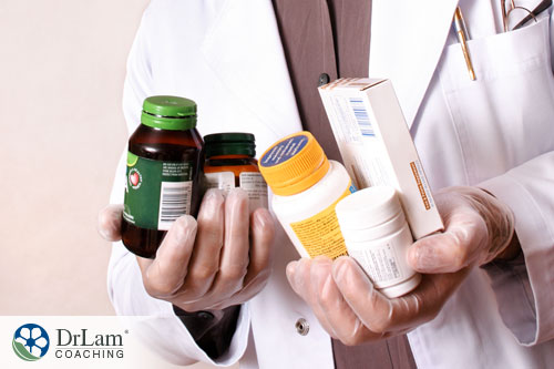 An image of a smiling male doctor holding different types of supplements for boosting your mood