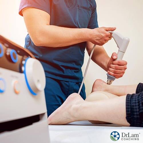 An image of a doctor giving a patient millimeter wave therapy on their heel