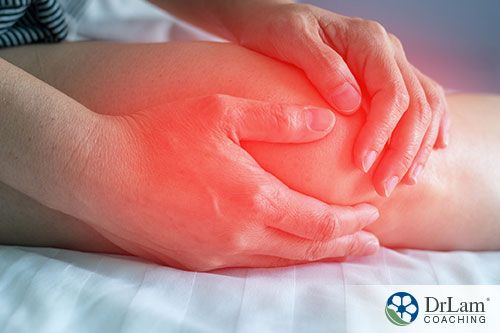 An image of someone holding their inflamed knee
