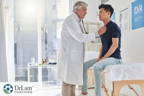 An image of a TCM practitioner checking a patient's vitals