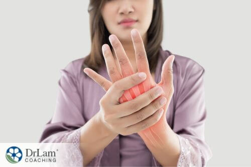 An image of a woman holding her hand in pain