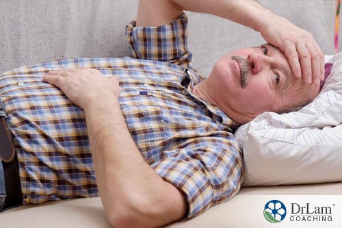 An image of a sick older man laying on the couch who could use some natural immune boosters