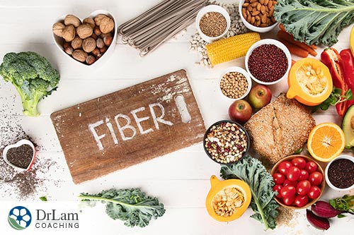 An image of high-fiber foods with fiber written on a wood cutting board