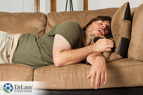 An image of a man asleep on the couch