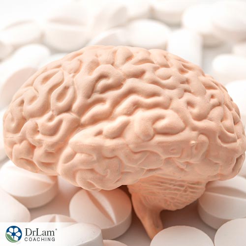 An image of a toy brain on white pills