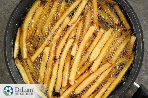 An image of someone frying french fries