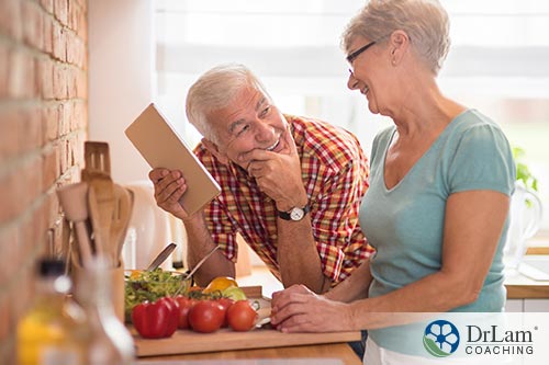 happy old couple smiling while preparing their diet plan holding it