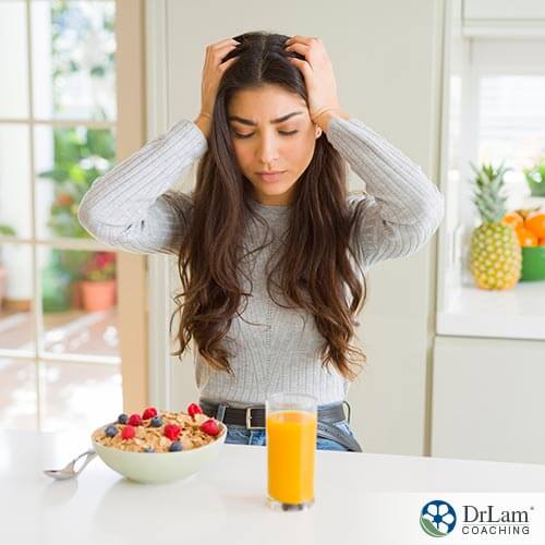 image of a woman having headache while eating through diet