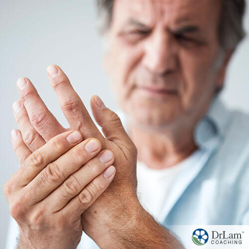 An image of an older man rubbing the joints of his hands