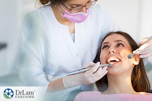 An image of a woman in a dentist's chair having her teeth looked at