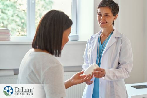 An image of a woman getting medicine from her doctor