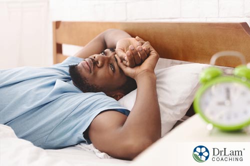 An image of a fatigued man in bed who is dealing with Post Finasteride Syndrome