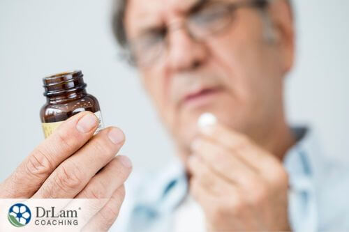 An image of a man checking the label of his probiotics