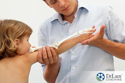 An image of a doctor measuring the bone growth of a child