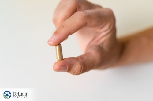 An image of a hand holding a capsule