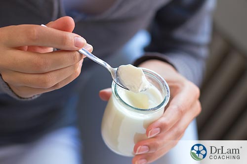 An image of a woman eating yogurt
