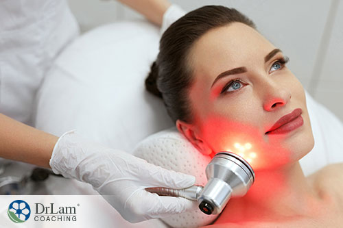 An image of a woman at the spa getting red light therapy on her face