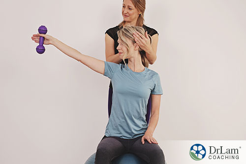 An image of a woman doing scoliosis exercises with help