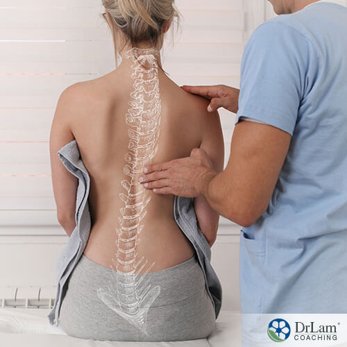 An image of a woman having her spinal alignment checked by a doctor