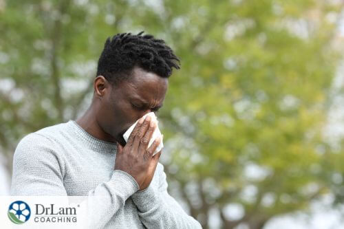 An image of a man sneezing