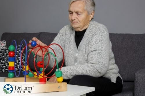 An image of an old man playing with a device
