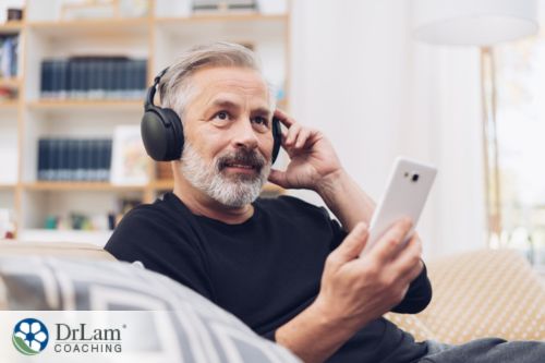 An image of a man listening to music