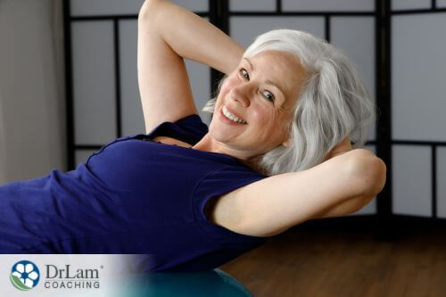 An image of a smiling woman exercising