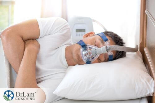 An image of a man sleeping with a CPAP mask on his face