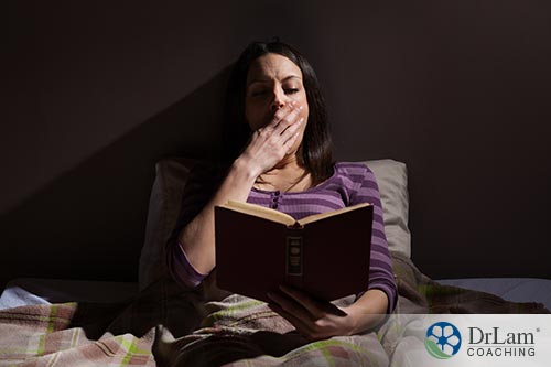 Woman reading book letting her fall to sleep as a tip of sleep training