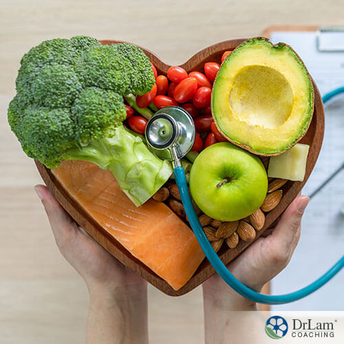 An image of healthy foods in a heart-shaped bowel with a stethoscope on top