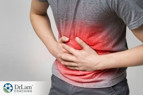 An image of someone holding their inflamed stomach