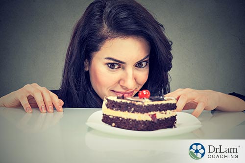 An image of a woman intensely looking at a slice of cake