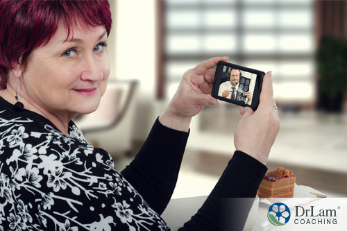 An image of a woman using her smartphone for a telehealth appointment