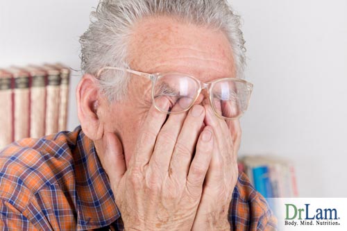 An elderly man looking tired rubbing his face in his hands, considering D-Ribose side effects