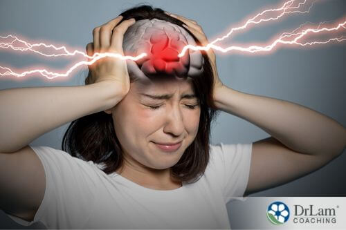 An image of a woman holding her head as lightning bolts come out of her brain