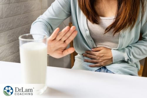 An image of a woman saying no to a glass of milk