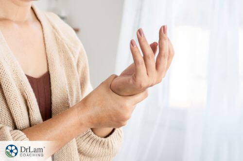 An image of a woman holding her wrist