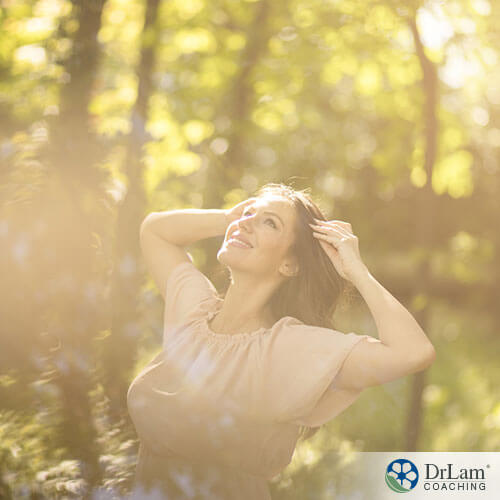 An image of a woman smiling in the sunlight
