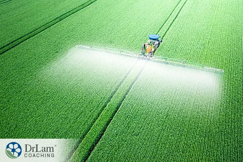 An image of a fertilizer tractor spraying a field