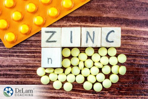 An image of zinc supplements and the word zinc on wood tiles
