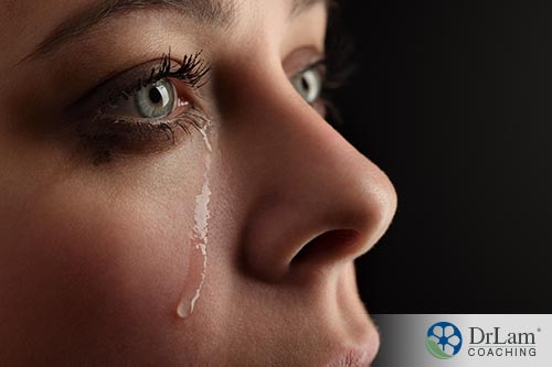 An image of a crying woman with dark circles