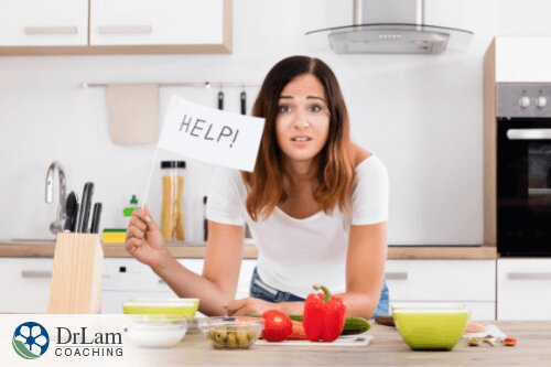 An image of a woman in the kitchen waving something with the word help