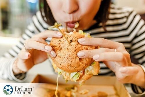 An image of a woman eating a burger